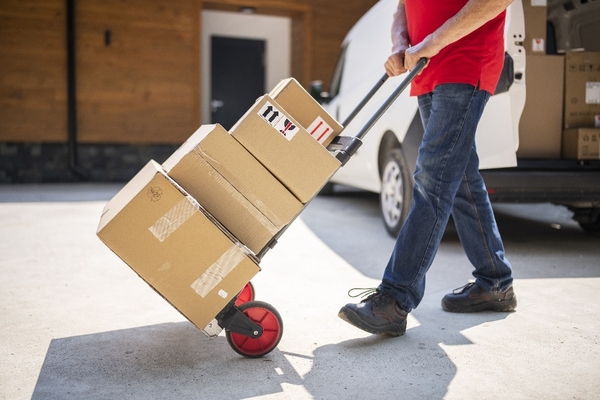 A mover transporting boxes using a dolly for a short distance move